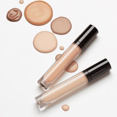 Cream concealer tubes with different shades and a 'shop now' button on a white background.